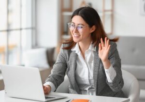 Woman waving on a video meeting