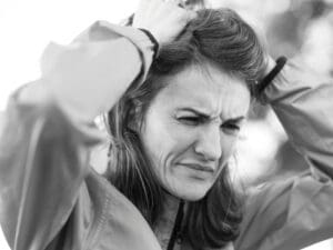The Hidden Women’s Health Issues Affecting Confidence at Work 2 woman looking in pain